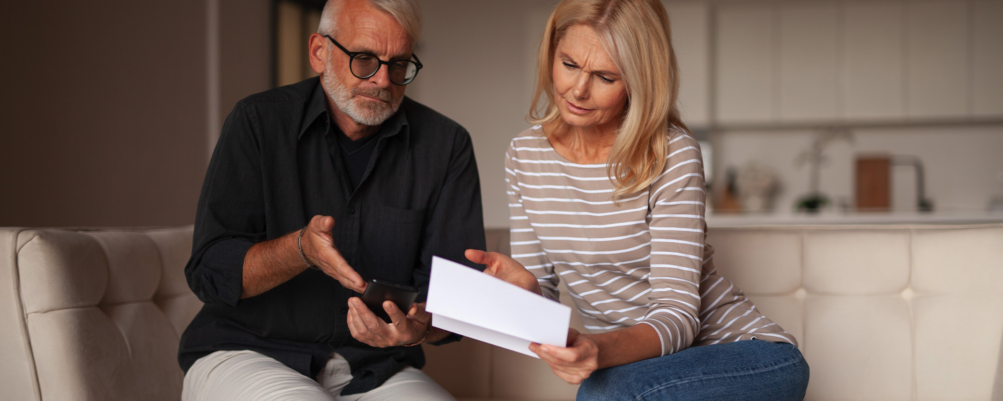 bad credit in a mature couple. confused people are surprised by the financial report.